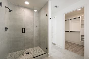 Frameless walk-in showers with stone flooring